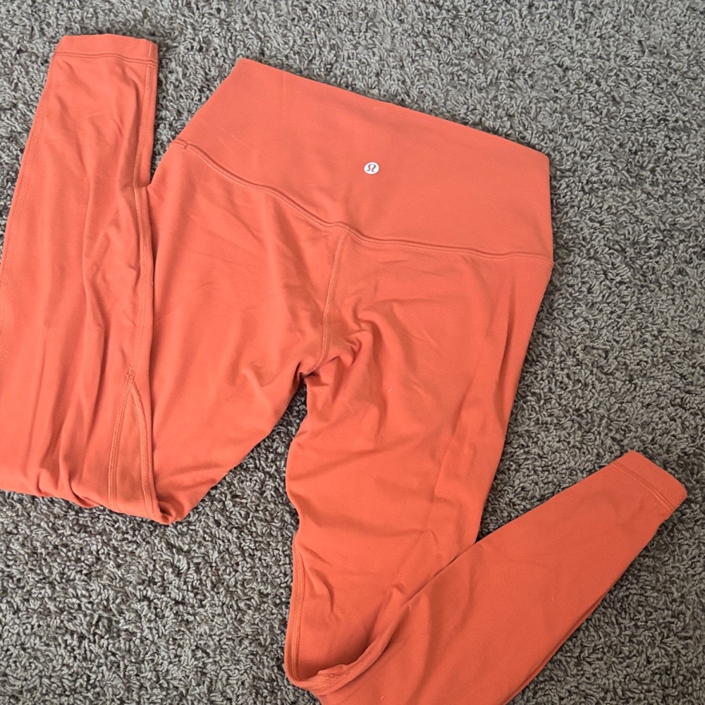 lululemon orange leggings with logo dot